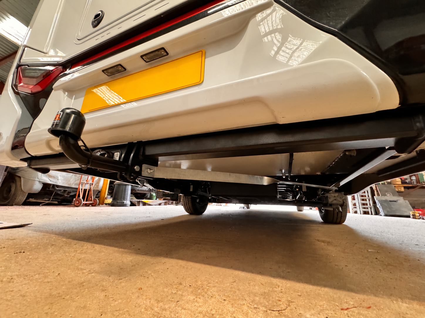 Full rear chassis extensions with diagonal cross braces and a swan-neck towbar